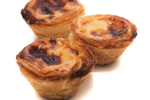 Famous Portuguese egg pastry tart called 'Pastel de Belem' isolated on white background.