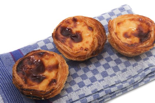 Famous Portuguese egg pastry tart called 'Pastel de Belem' isolated on white background.