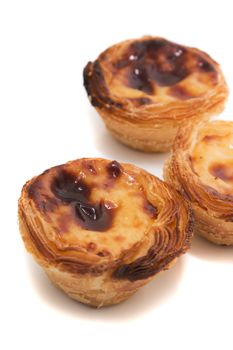 Famous Portuguese egg pastry tart called 'Pastel de Belem' isolated on white background.