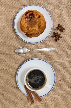 Typical Portuguese breakfast with expresso coffee and egg custard pastry.