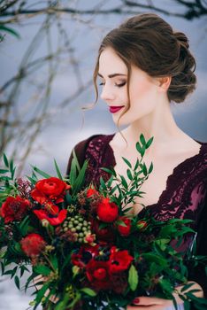 groom in a brown and bride in burgundy in the mountains Carpathians