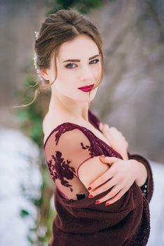 groom in a brown and bride in burgundy in the mountains Carpathians