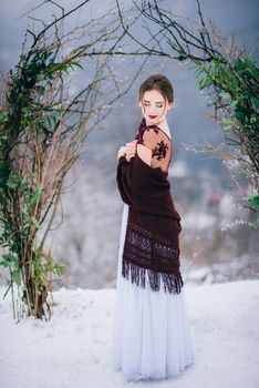 groom in a brown and bride in burgundy in the mountains Carpathians