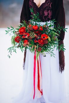 groom in a brown and bride in burgundy in the mountains Carpathians