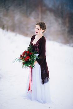 groom in a brown and bride in burgundy in the mountains Carpathians