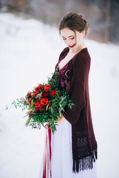 groom in a brown and bride in burgundy in the mountains Carpathians