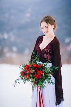 groom in a brown and bride in burgundy in the mountains Carpathians