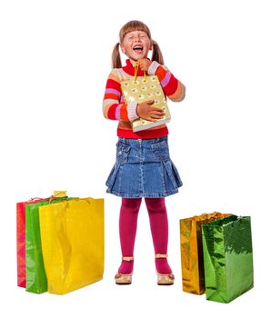 Smiling six years Girl holding presents bags isolated