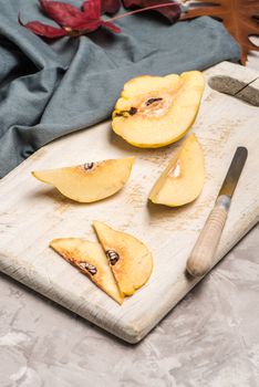 Quince fruit parts on concrete kitchen countertop.