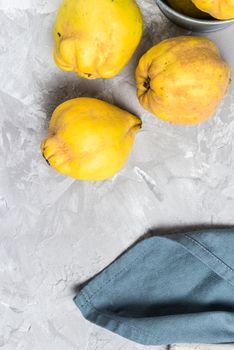 Ripe quince fruits on kitchen countertop.