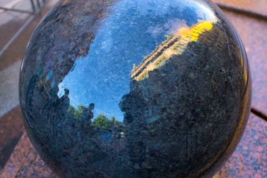 a person's reflection in the ball of the city of St. Petersburg