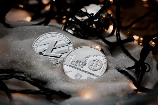 Digital currency physical metal bitcoin coin. Crypto currency christmas snow composition.