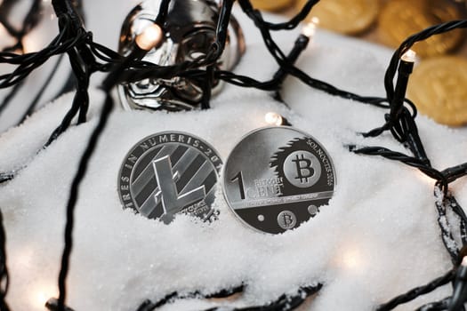 Digital currency physical metal bitcoin coin. Crypto currency christmas snow composition.