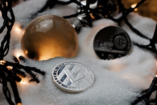 Digital currency physical metal bitcoin coin. Crypto currency christmas snow composition.
