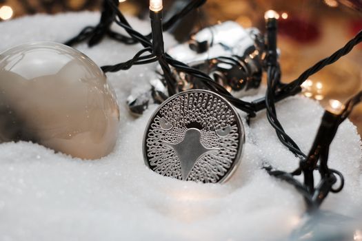 Digital currency physical metal bitcoin coin. Crypto currency christmas snow composition.