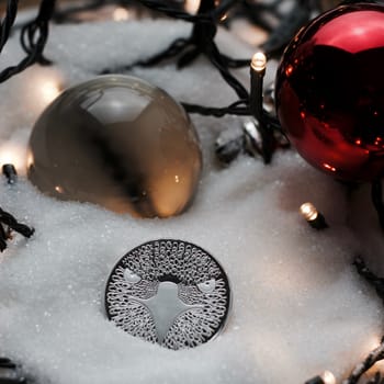 Digital currency physical metal bitcoin coin. Crypto currency christmas snow composition.