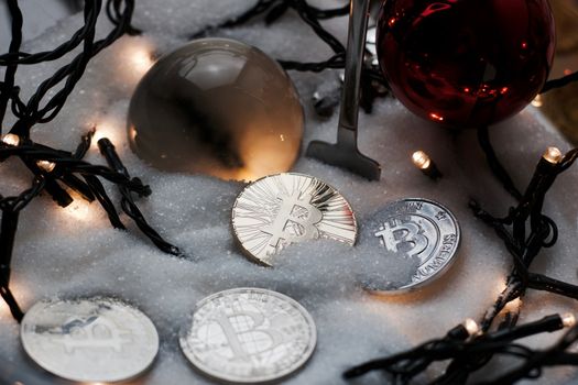 Digital currency physical metal bitcoin coin. Crypto currency christmas snow composition.