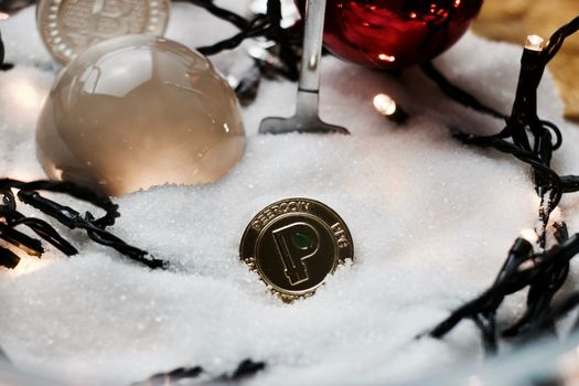 Digital currency physical gold metal peercoin coin. Christmas concept.