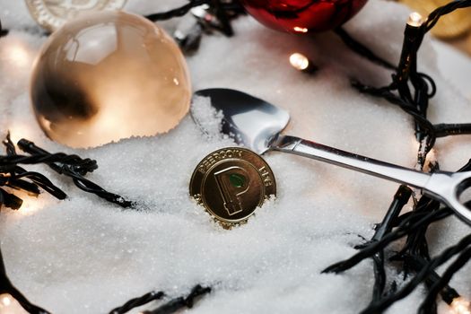 Digital currency physical gold metal peercoin coin. Christmas concept.