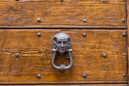 Close up of rustic old door in Spoleto, Italy.