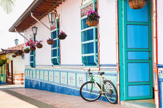 Bicycle next to a beautiful blue and white house at Guatape, Colombia