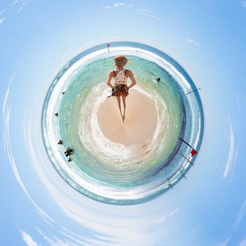 A woman relaxing at the beach of Koggala from a tiny world perspective