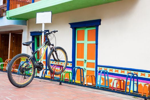 Lonely bicycle parked on a colorful rack at the beautiful Guatape city in Colombia