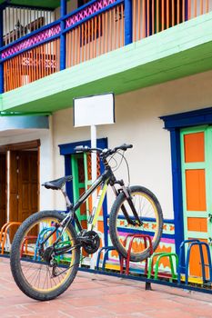 Lonely bicycle parked on a colorful rack at the beautiful Guatape city in Colombia