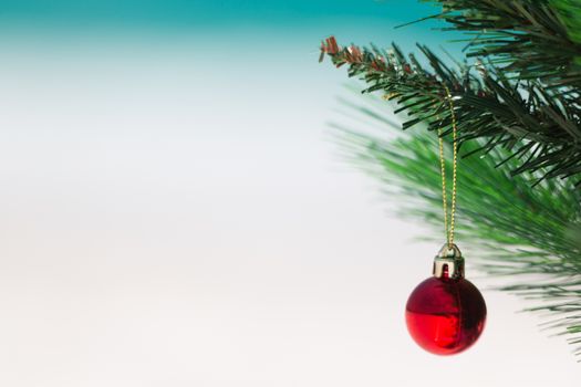 Christmas tree at the beach.  Closeup with focus on red bauble shallow dof and lots of space for copy