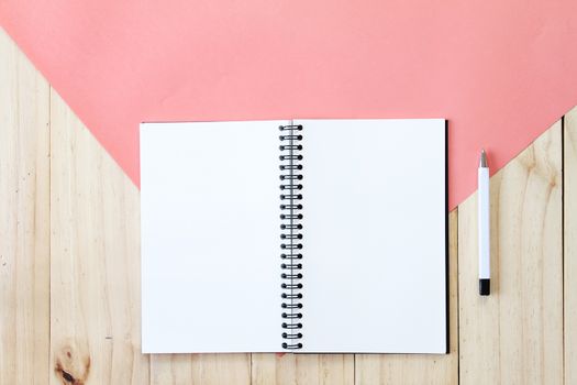 Still life, business, office supplies or education concept : Top view image of open notebook with blank pages on wooden background, ready for adding or mock up