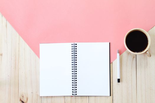 Still life, business, office supplies or education concept : Top view image of open notebook with blank pages and coffee cup on wooden background, ready for adding or mock up