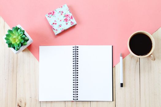 Still life, business, office supplies or education concept : Top view image of open notebook with blank pages, accessories and coffee cup on wooden background, ready for adding or mock up