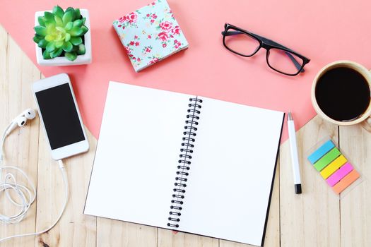 Still life, business, office supplies or education concept : Top view image of open notebook with blank pages, accessories and coffee cup on wooden background, ready for adding or mock up