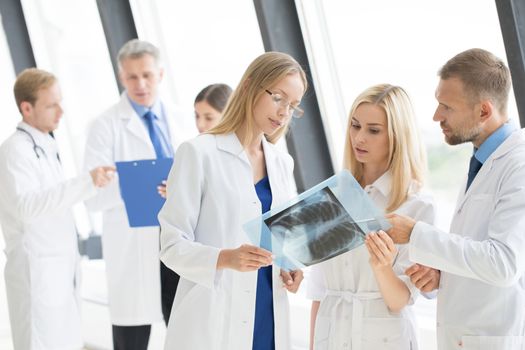 Group of doctors look and discuss x-ray in a clinic or hospital