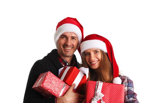 Happy beautiful couple holding many christmas gift boxes isolated on white background