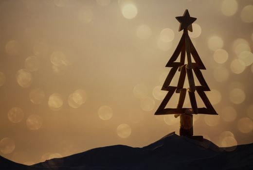 For Australians, Christmas is hot summer days and casual celebrations outdoors or down at the beach.  A driftwood Christmas tree stands in the sand of the beach in the morning light with soft bokeh