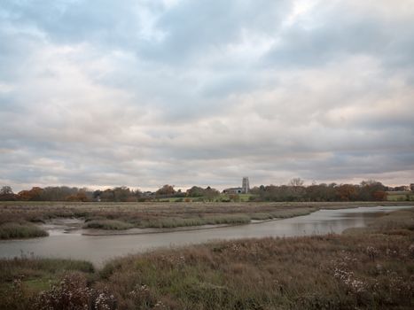 stream estuary running through countryside autumn Alresford Creek church; essex; england; uk