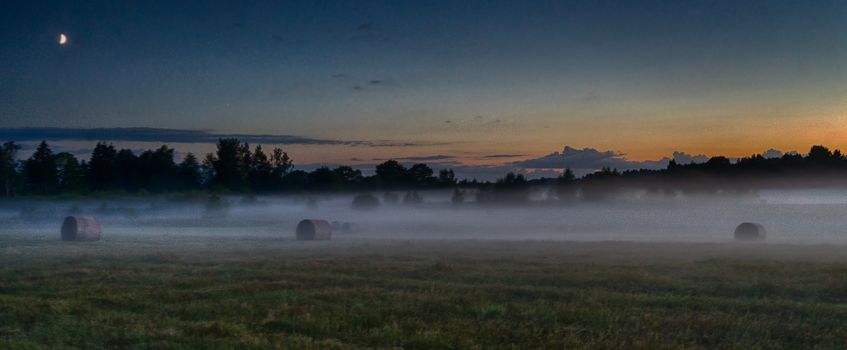 Latvia vidzeme landscape at sunset with fog and mist