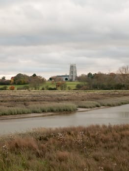stream estuary running through countryside autumn Alresford Creek church; essex; england; uk