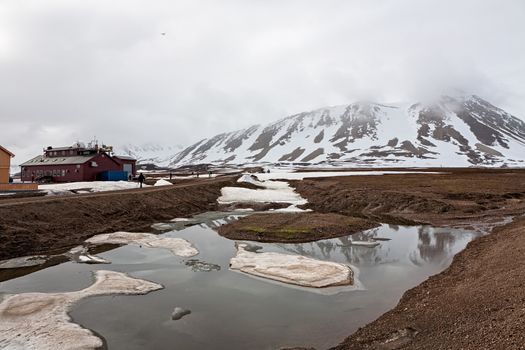 Snowy mountains and meteorological station in a foggy day in Ny Alesund, Svalbard islands, Norway