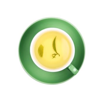 Full cup of clear green tea with floating leaves on green saucer isolated on white background, close up, elevated top view