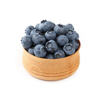 Portion of fresh blueberry berries in rustic wooden bowl isolated on white background, close up, high angle view