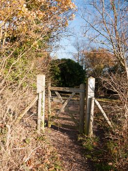 countryside open gate public pathway wooden fence boundary autumn; essex; england; uk