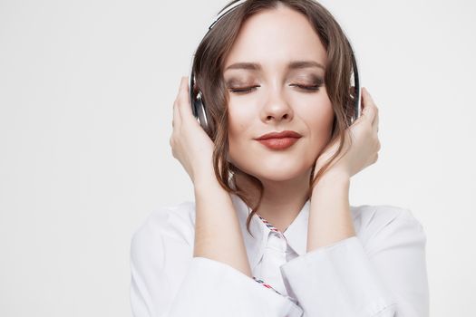 Beautiful girl in headphones listens to music. Slow motion.