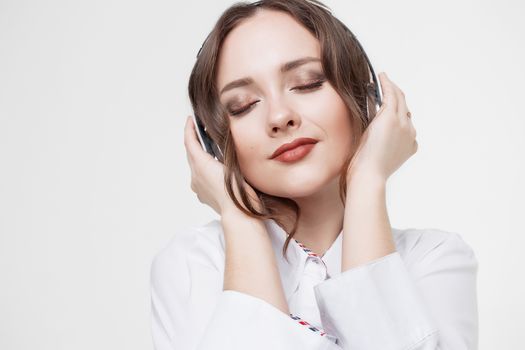 Beautiful girl in headphones listens to music. Slow motion.