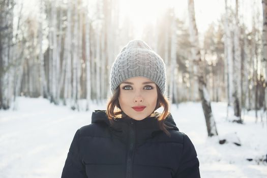 Beautiful young girl in a white winter forest.