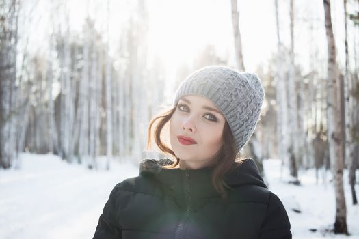Beautiful young girl in a white winter forest.
