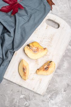 Quince fruit parts on concrete kitchen countertop.