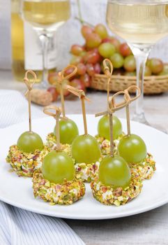 Canape  of cottage cheese cushions  in pistachios with grapes 