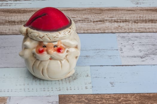 Christmas and New Year's decorations. Beauty Santa Claus toy made of porcelain on the vintage table 
